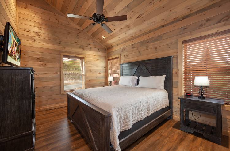 bedroom with wood walls