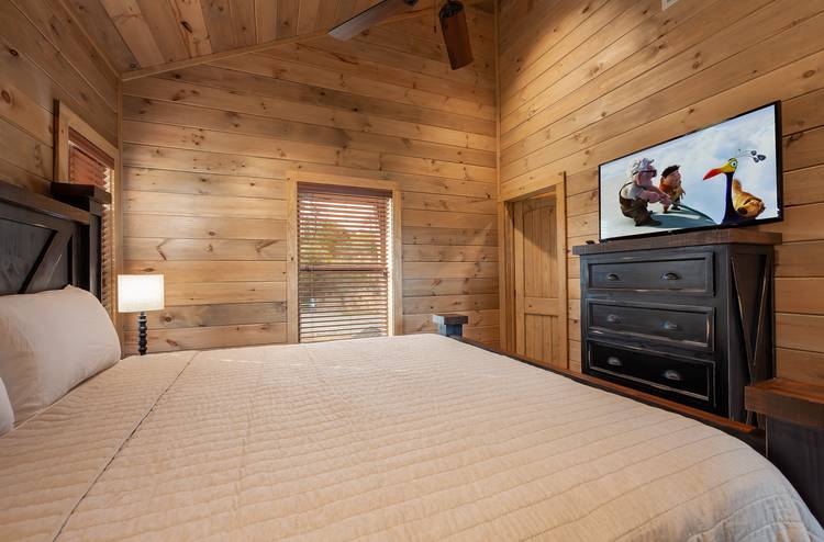 bedroom with wood walls in a smoky mountain cabin