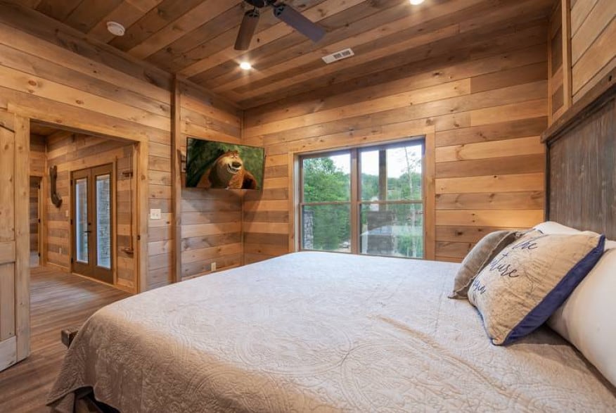 bedroom in smoky mountain cabin with wood walls